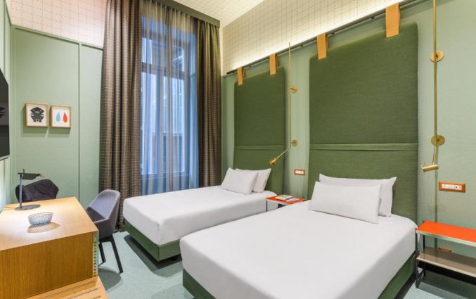 Slaapkamer van hotel Room Mate Giulia in Milaan